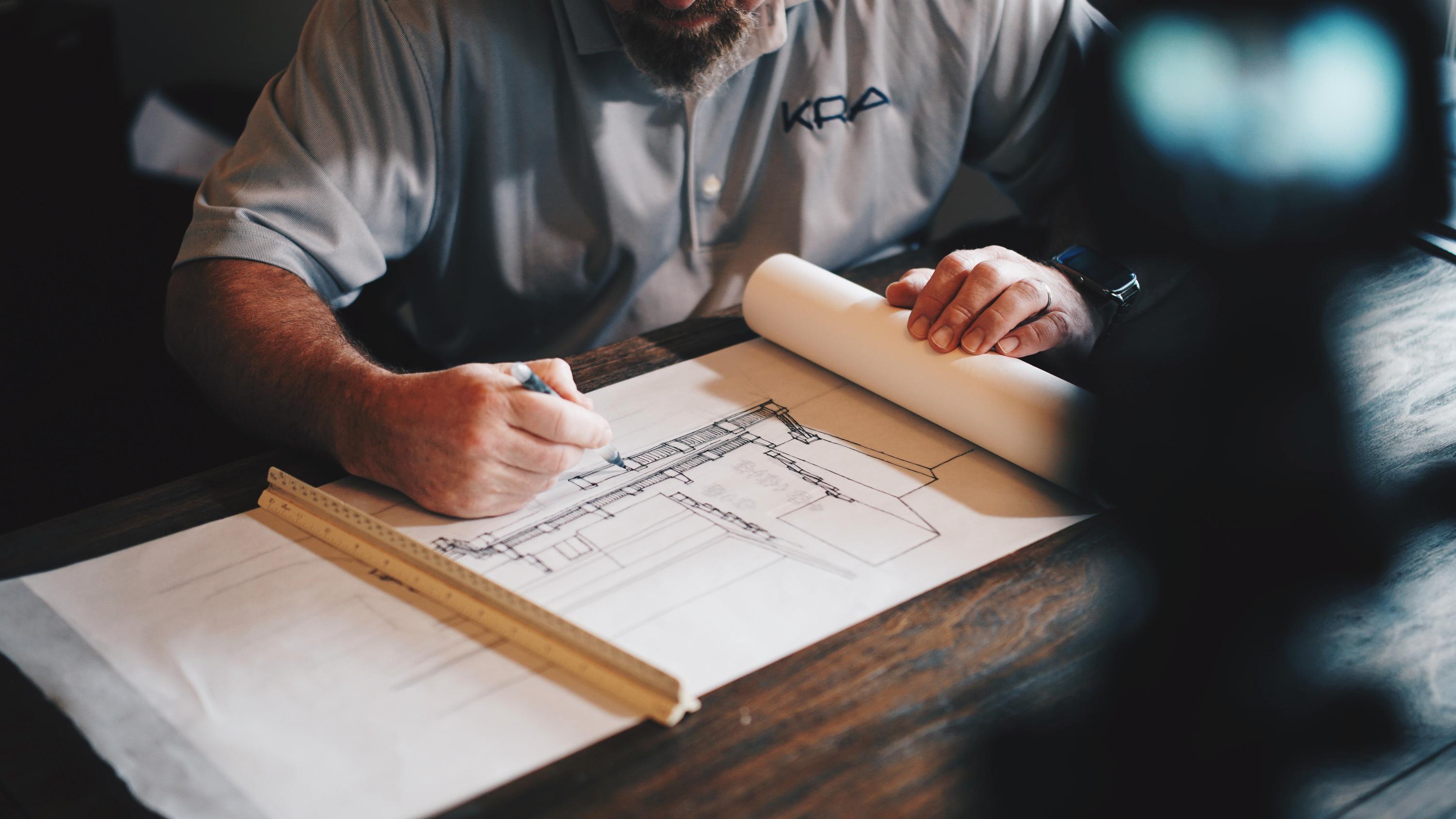 man working on site plans for a new building development